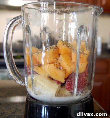 A beautifully prepared glass of Cantabananaberry Smoothie, garnished with fresh fruit on the rim