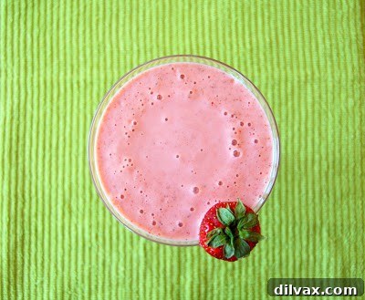 Another enticing angle of the Cantabananaberry Smoothie, highlighting its smooth and refreshing texture in a glass