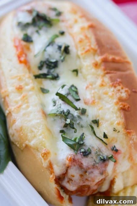 No-Fuss Meatball Sub Perfection 7 Meatballs, pasta sauce, Italian cheeses, and seasoning in a torpedo roll ready to be broiled