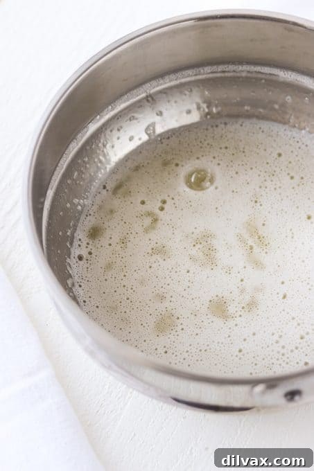 Pillowy Mallow Frosting 5 Heating egg whites and sugar to make frosting.