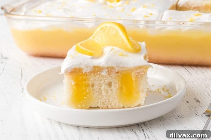 Zesty Lemon Poke Cake with Fluffy Marshmallow Frosting, perfect for spring.