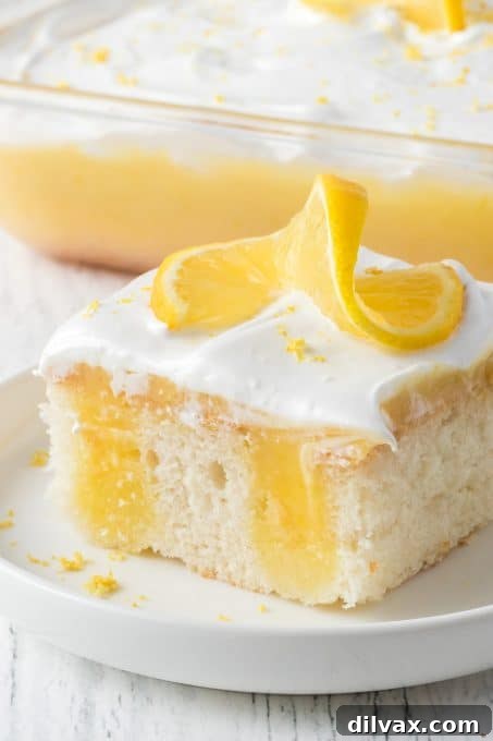 Beautifully frosted Lemon Poke Cake, ready to be served, highlighting its irresistible texture.