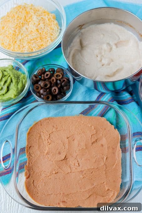 Mashed refried beans, ready to be spread as the base layer of the 7-Layer Dip.