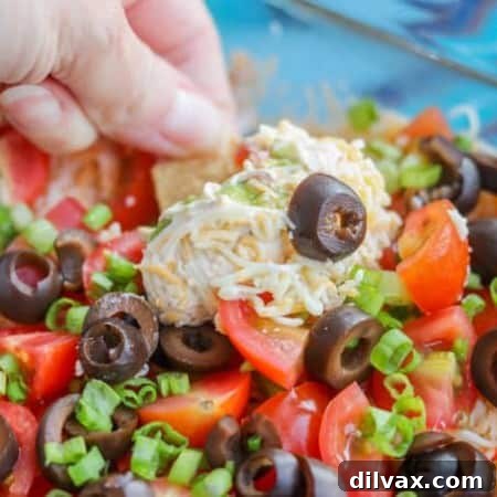 7-Layer Dip prepared in a square dish.