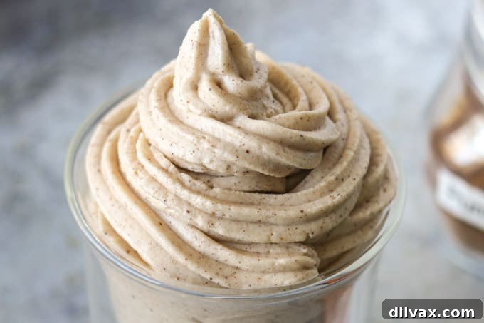 Pumpkin Spice Frosting piped onto a dessert.