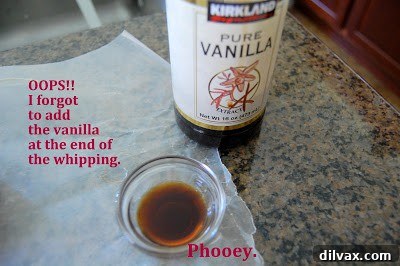 Applying a layer of whipped cream frosting to the genoise cake.