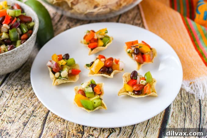 A plate full of tortilla scoops brimming with colorful Texas Caviar, an easy and delicious appetizer.