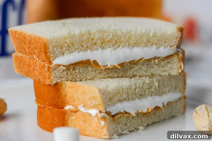 Effortless Fluffernutter Bliss 2 A perfectly prepared Fluffernutter sandwich, showcasing a thick layer of peanut butter and marshmallow fluff on white bread.