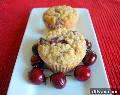 Juicy Cherry & Hearty Oat Muffins 2 Freshly baked cherry oatmeal muffins on a cooling rack, ready to be enjoyed.