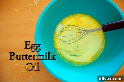 Juicy Cherry & Hearty Oat Muffins 5 Buttermilk, egg, and canola oil mixed together in a bowl, ready to be combined with dry ingredients.