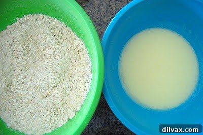 Juicy Cherry & Hearty Oat Muffins 6 Wet ingredients being poured into the bowl of dry ingredients.