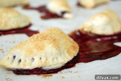 Flaky Cherry Blueberry Turnovers 14 Assorted baked goods and pastries on display at a market, including turnovers