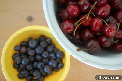 Flaky Cherry Blueberry Turnovers 4 Several homemade cherry blueberry turnovers arranged on a baking sheet