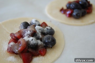 Flaky Cherry Blueberry Turnovers 5 Close-up of pastry dough being prepared on a lightly floured surface