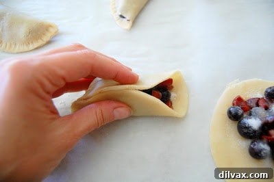 Flaky Cherry Blueberry Turnovers 8 Platter of freshly baked cherry blueberry turnovers, some with a bite taken out