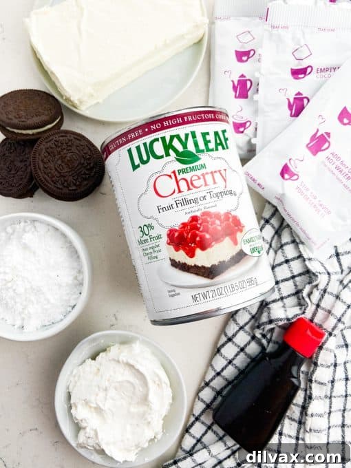 Key ingredients laid out for making a decadent chocolate cheesecake with cherry topping.