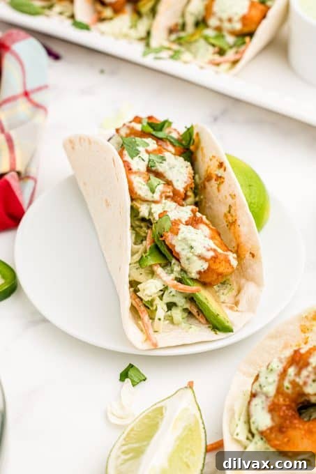 A taco with shrimp and coleslaw.