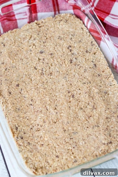 Chewy Toffee Coconut Oat Squares 7 A pan of oatmeal bars with toffee and coconut ready for the oven.