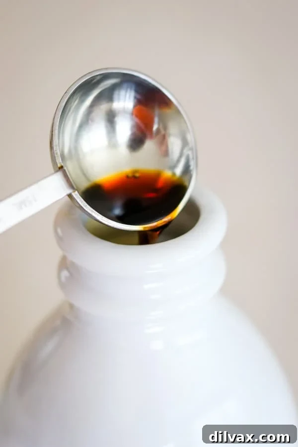 Whip Up French Vanilla Coffee Creamer 10 Pouring vanilla extract into the Homemade French Vanilla Coffee Creamer mixture.