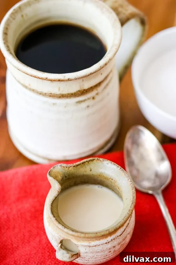 Whip Up French Vanilla Coffee Creamer 2 A spoon with Homemade French Vanilla Coffee Creamer drizzling from it.