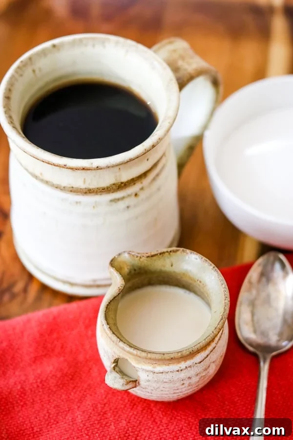 Whip Up French Vanilla Coffee Creamer 4 A cup of coffee, a spoon, a sugar bowl and Homemade French Vanilla Coffee Creamer on a tray.