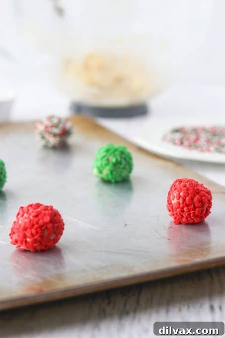 Close-up of vibrant, colorful sprinkle cookie dough balls, pre-baked and ready for the oven.