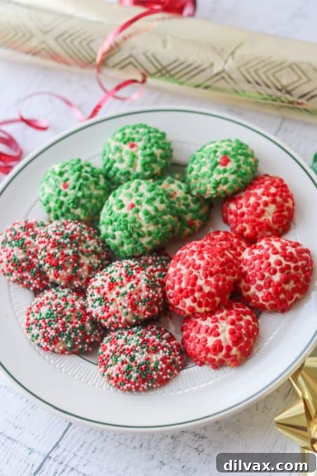 A charming plate overflowing with freshly baked cream cheese sprinkle cookies, ready for holiday enjoyment.
