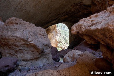 Looking back at the Tonto Natural Bridge from a distance, showing its full scale.