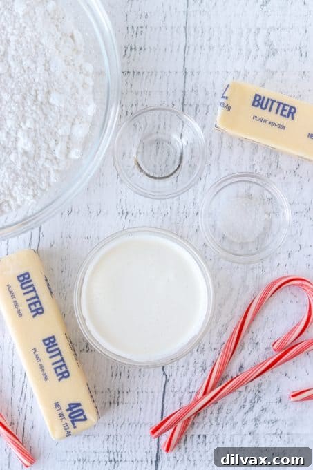 Whipped Peppermint Bliss 4 A selection of essential ingredients for making Peppermint Buttercream Frosting, including butter, extract, and sugar.