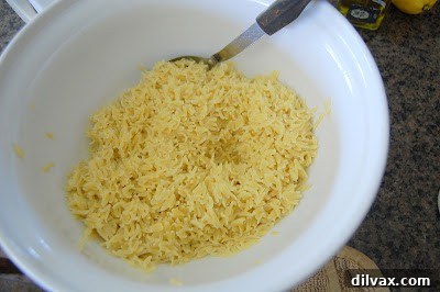 A close-up shot of a whisk combining high-quality olive oil, fragrant garlic powder, sea salt, and freshly ground black pepper in a mixing bowl, creating a rich marinade.