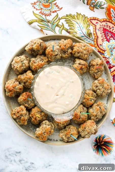 A generously filled plate of sausage and cheese appetizers, ready to be served.