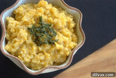 Butternut squash risotto cooking in a pan, with a creamy texture.