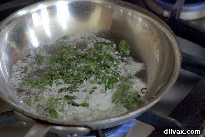 Crispy fried sage leaves draining on a paper towel.