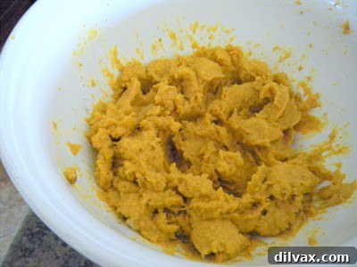Butternut squash pureeing in a food processor with heavy cream.