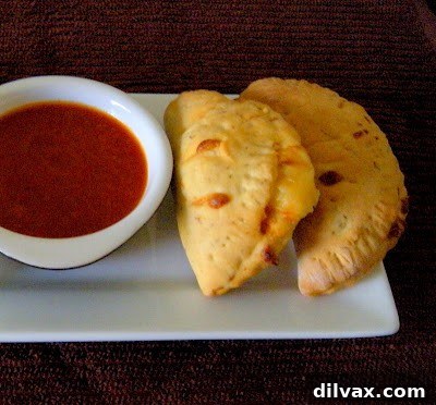 Bite Sized Pepperoni Calzones 6 Close-up of golden brown calzone with visible pepperoni and cheese