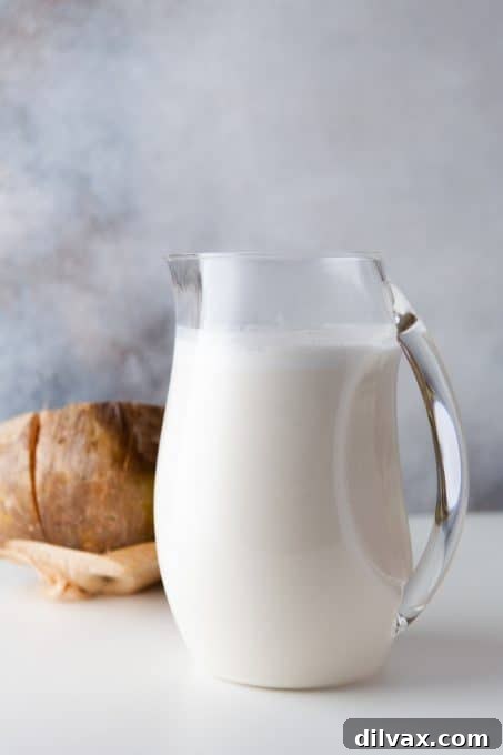 Tropical Coconut Bliss 5 A large pitcher filled with a creamy coconut drink, ready to be served over ice.