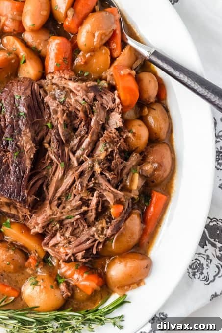 Carrots, potatoes and a roast made in a crockpot.