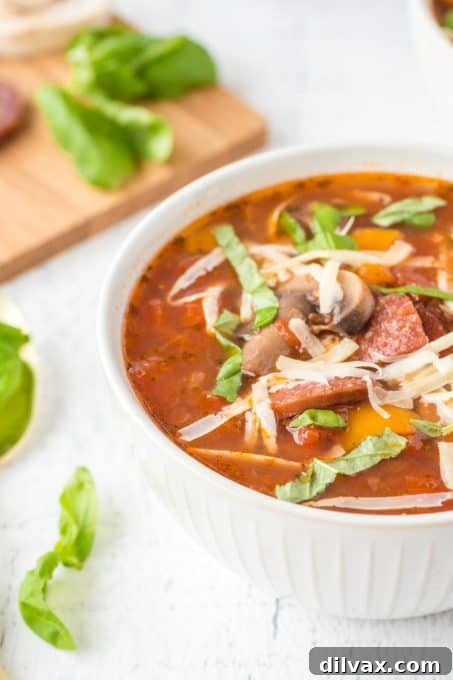 A close-up of Pizza Soup in a bowl, showing the rich texture and ingredients.