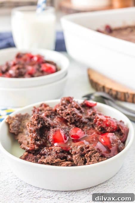 Effortless Chocolate Cherry Delight 7 Individual bowls containing cherry pie filling and chocolate cake mix, ready to be combined.