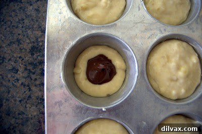 Salted Nutella Banana Muffins topped with a drizzle of Nutella