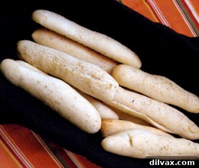 Golden brown, freshly baked Olive Garden style breadsticks, perfectly seasoned and ready to enjoy.
