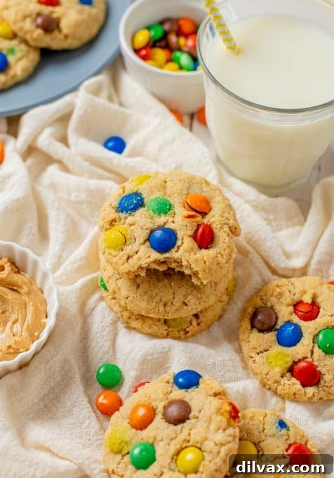 Ultimate Peanut Butter Oatmeal M&M Cookies 8 A bite taken out of an oatmeal cookie with M&M's and peanut butter.