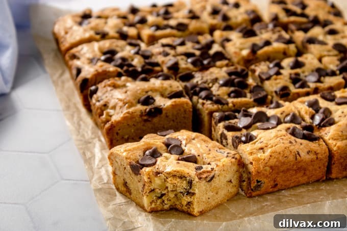 A corner blondie with a bite taken out, revealing gooey chocolate chips and a soft, chewy texture.