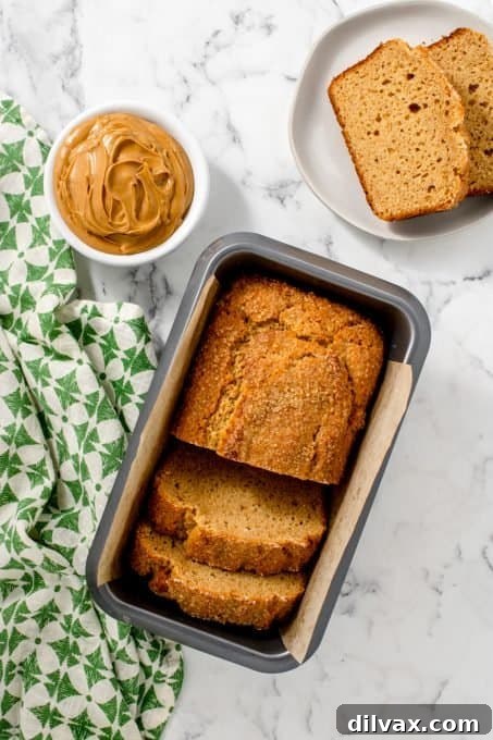 Golden Peanut Butter Quick Bread 7 A freshly baked loaf of quick bread, featuring a peanut butter twist, cooling on a wire rack.