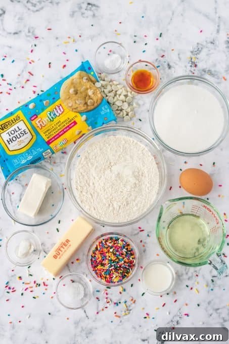 A selection of ingredients laid out, ready for baking sprinkle-filled cake batter cookies.