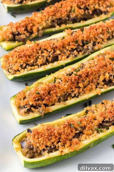 Hearty Mushroom Onion Zucchini Bake 3 Two halves of Mushroom and Onion Stuffed Zucchini on a plate.