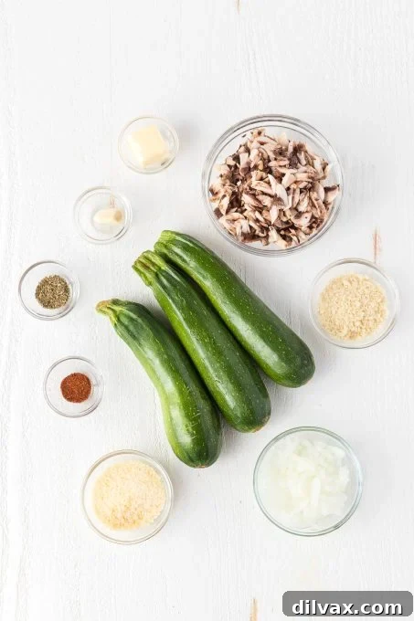 Savory Mushroom Onion Zucchini Boats 4 Ingredients for Mushroom and Onion Stuffed Zucchini laid out on a cutting board.