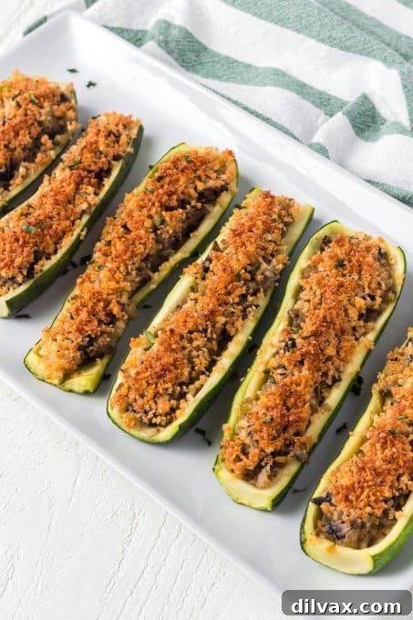 Savory Mushroom Onion Zucchini Boats 8 Close-up of a Mushroom and Onion Stuffed Zucchini boat, showing the rustic bread crumb topping.