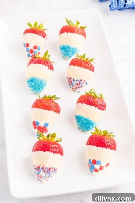 Various patriotic strawberries on a white platter