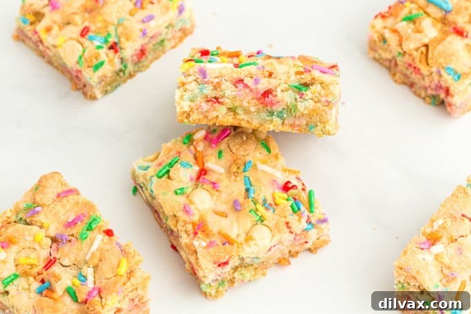 A plate of colorful Funfetti Ooey Gooey Bars ready to be enjoyed, showcasing their soft, sprinkle-filled texture.